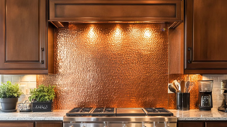 the warm tones of copper and dark wood are supported by a travertine brick tile