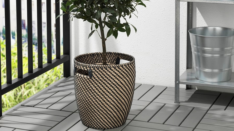 A RÅGKORN planter sitting on a balcony