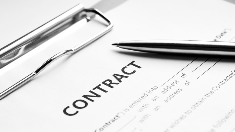 a pen on a contract document