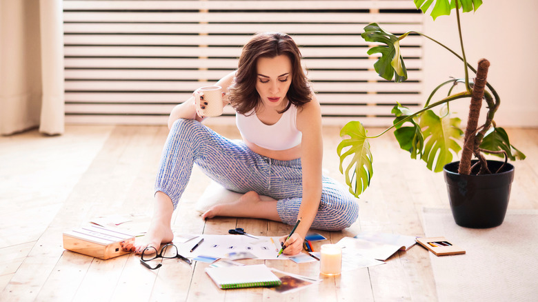 woman writing on the floor