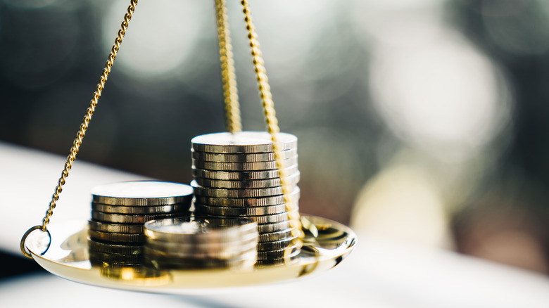 coins stacks on balance scale