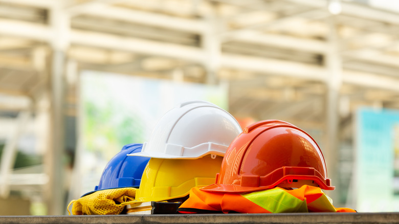 three hard hat helmets