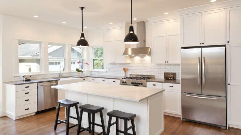 A modern kitchen with various lighting, including flush-mount ceiling lights