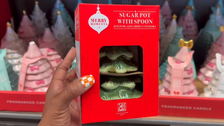 A shopper holding Aldi's Christmas tree-shaped ceramic sugar pot