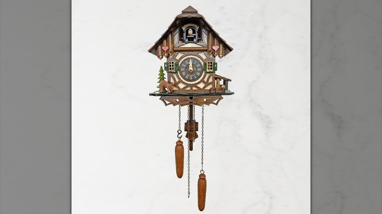 An Engstler Battery Operated Cuckoo Clock with a Chalet and Deer design is shown in a detail shot
