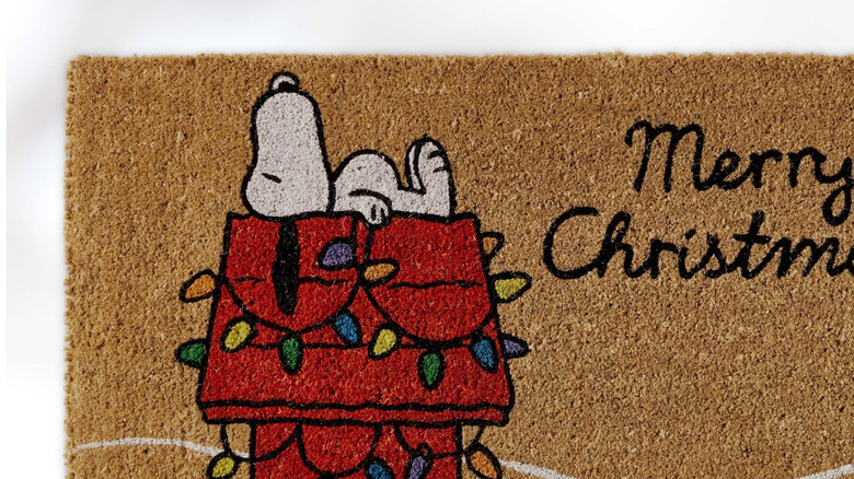 A Peanuts Snoopy Holiday Door Mat is shown in a detail shot