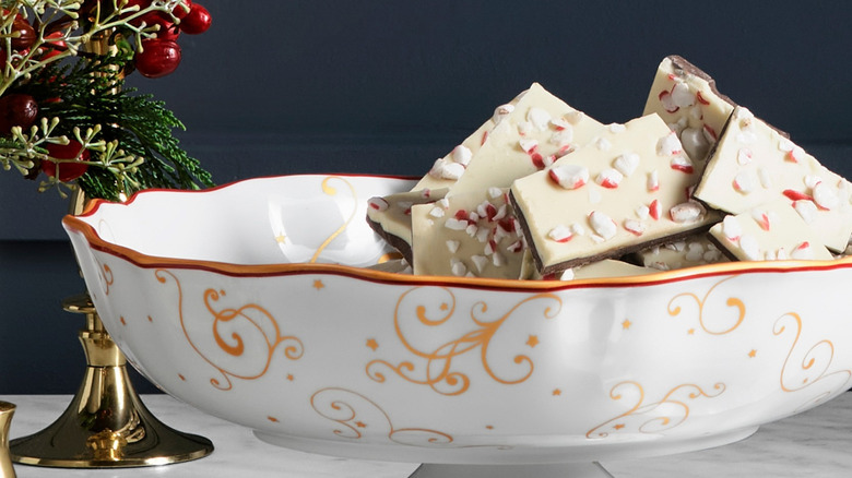 A decorative pedestal bowl is filled with Williams Sonoma peppermint bark