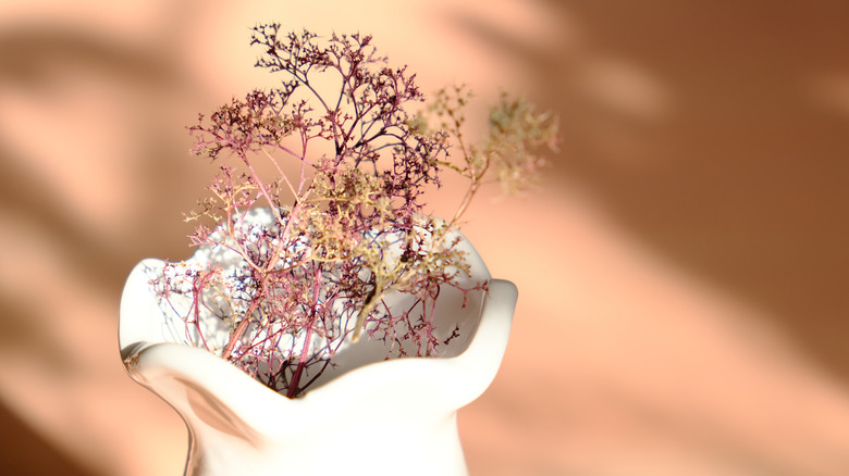 White vase against rust background