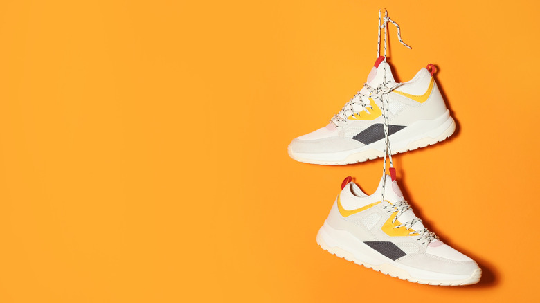 Orange wall with sneakers