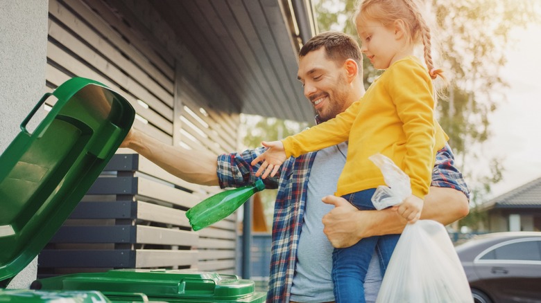 Dad and daughter at trashcans