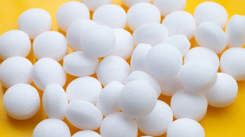Mothballs on yellow background