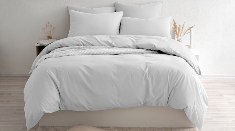 Bed made with a down comforter