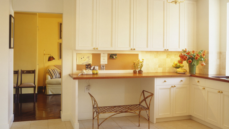 kitchen desk with bench in bright, modern kitchen.