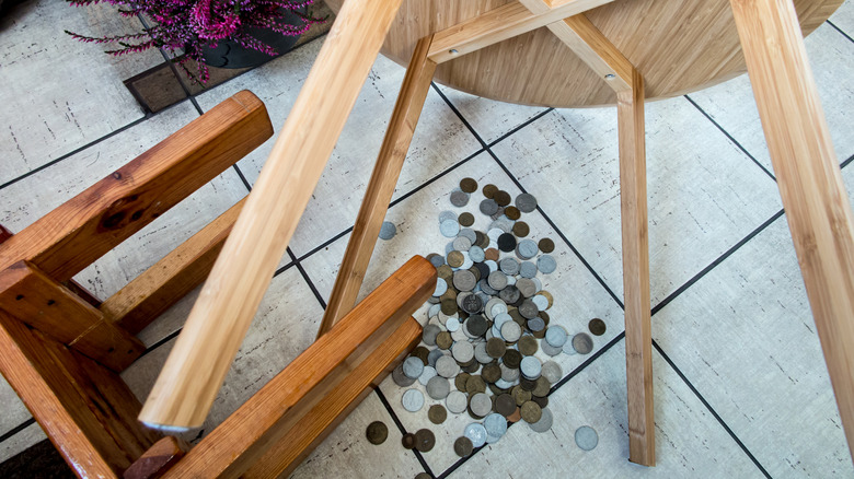 Fixing two chairs on the floor with coins