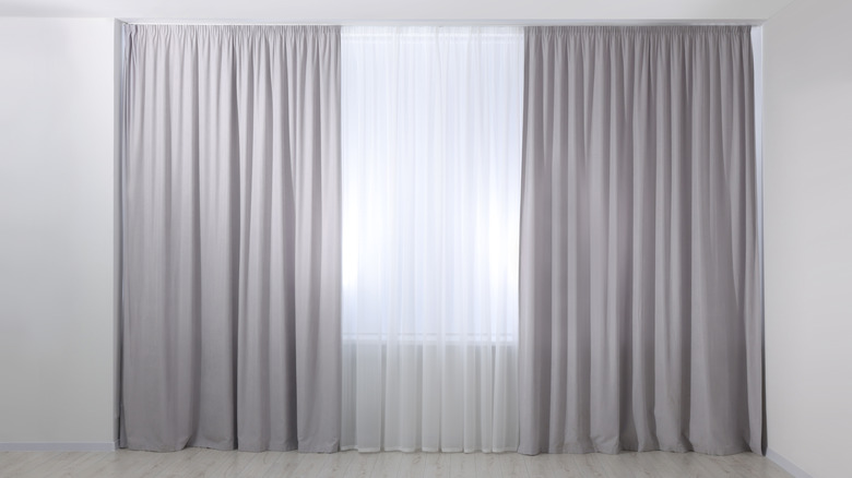 Gray outer curtain with white inner curtain in a room