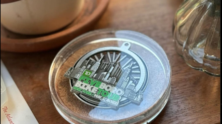 race medal coaster on table next to other home items