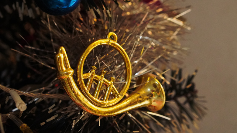 close up of a gold metal instrument ornament on a Christmas tree