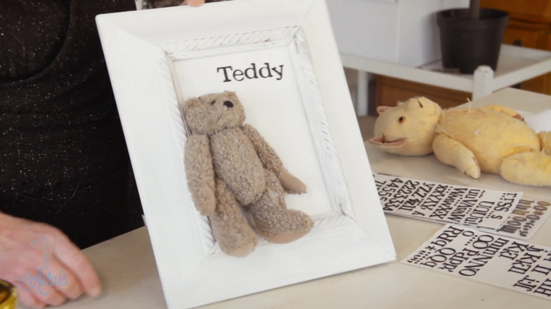 Teddy bear in white frame