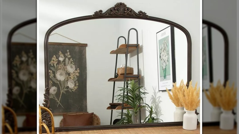 A baroque wood mantel mirror on a mantel from Hobby Lobby