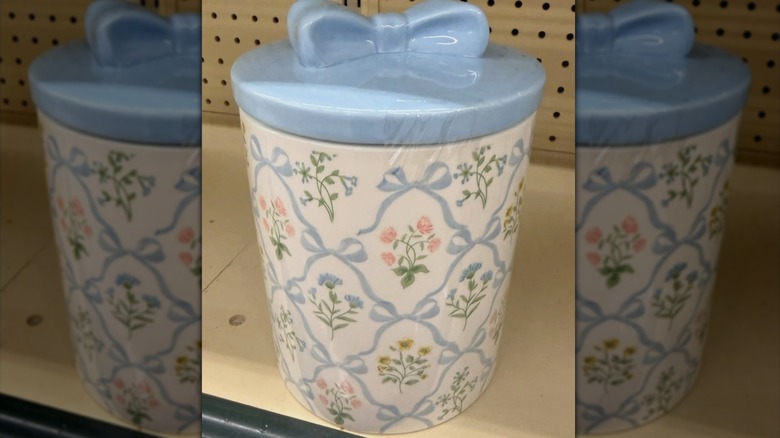 A blue floral bow canister on a shelf at Hobby Lobby