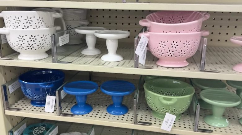 Mini ceramic cake stands and colanders on a shelf at Hobby Lobby