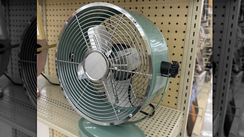 A retro green desk fan on a shelf in Hobby Lobby