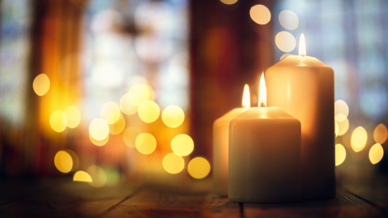 A room glows with the light of many candles.