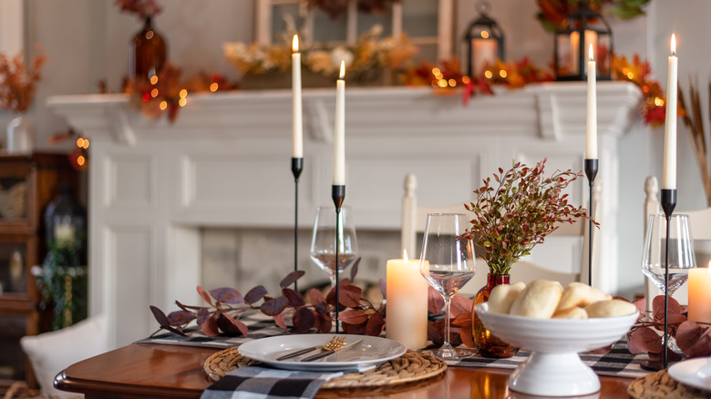 A dining room and table are decorated for Thanksgiving