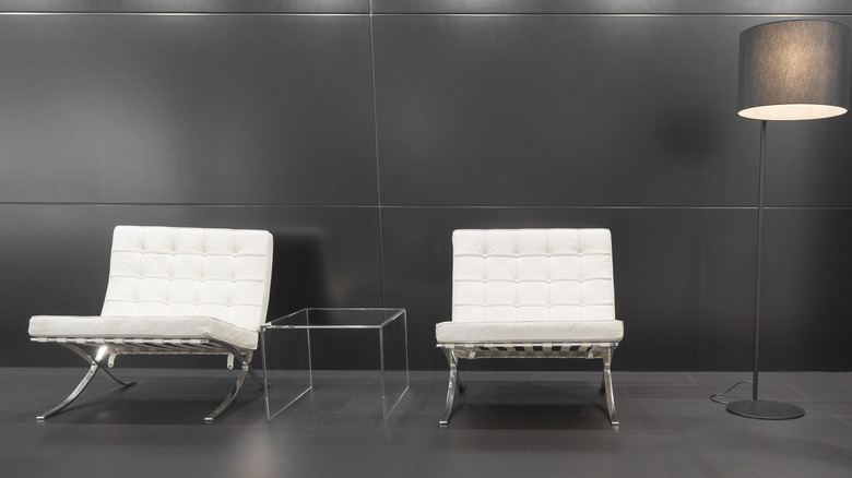 Two Barcelona Chairs and a glass table