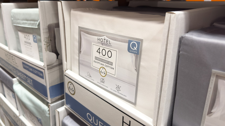 Egyptian cotton sheet packages on shelves in a store