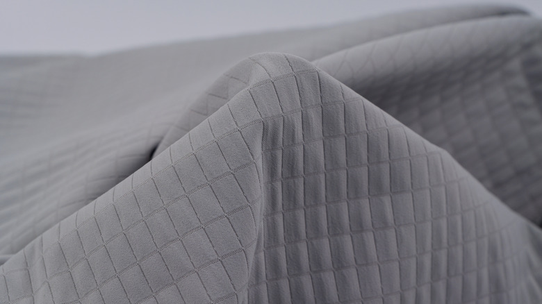 A close up of a gray twill fabric with a diagonal pattern