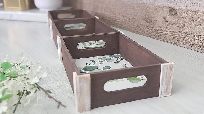 Three-section tray made using Dollar Tree wood crates with wallpaper on the bottom