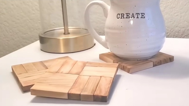 DIY coasters made from Dollar Tree wood tumbling blocks on a table