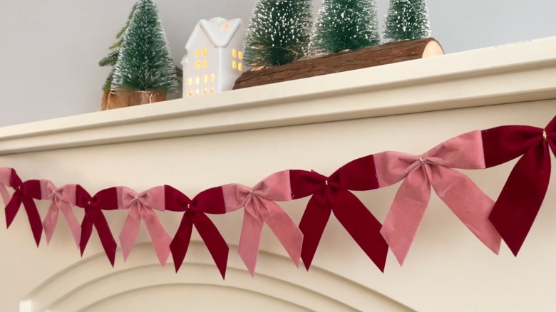 red and pink christmas bow garland on mantel