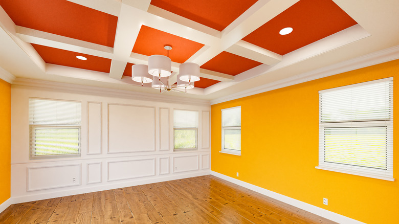 A boldly-painted room with orange and gold ceiling and walls.
