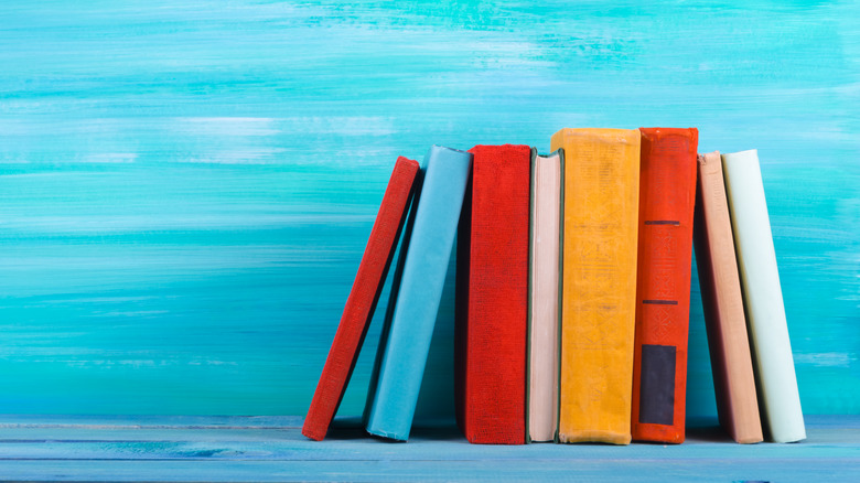 Books on a colorful blue shelf.