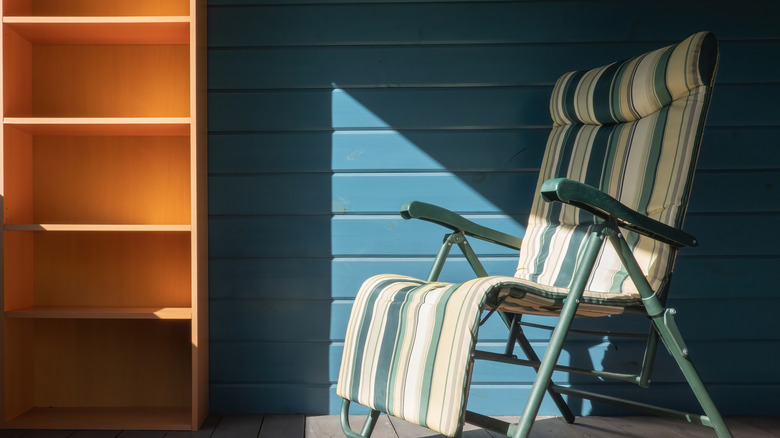 Orange bookshelf against blue wall