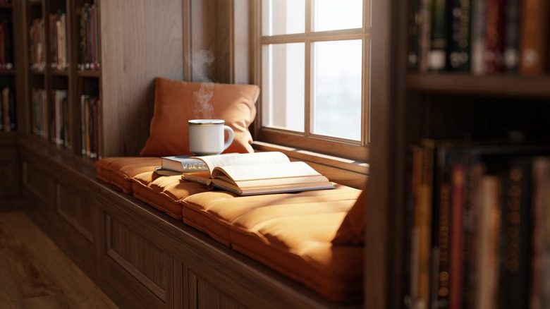 A cozy reading nook in a bay window.