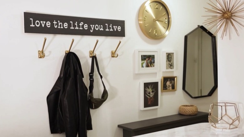 Gold statement hooks blend into a wall display featuring gold accents.