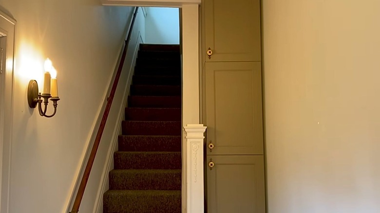 A DIY Ikea cabinet fills an awkward nook in a small entryway.