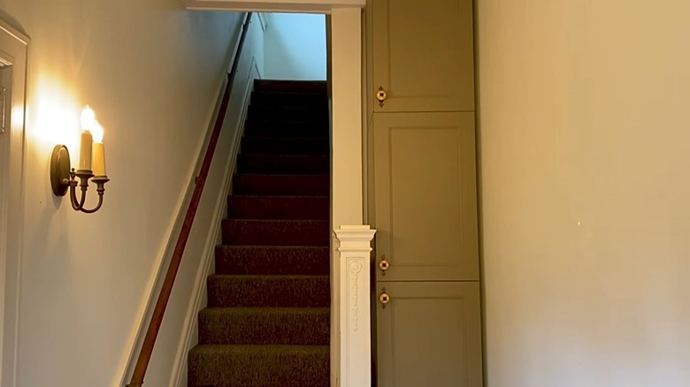 A DIY Ikea cabinet fills an awkward nook in a small entryway.