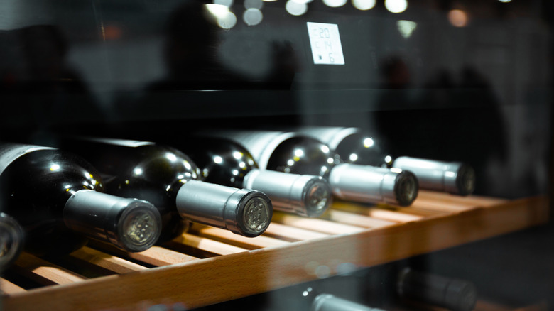 Wine bottles stored in a fridge
