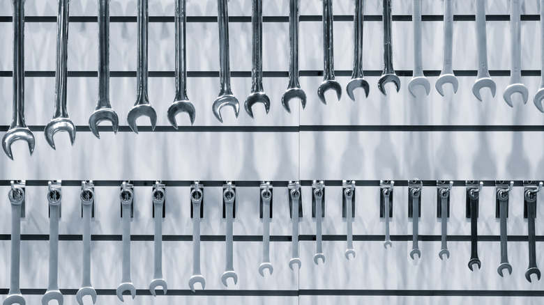 Wrenches hanging from hooks installed on a slatwall