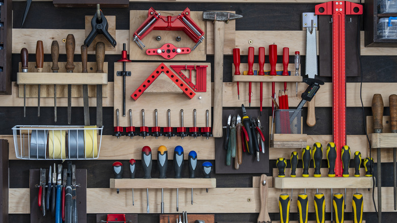 Various old tools stored on a French cleat wall-storage system
