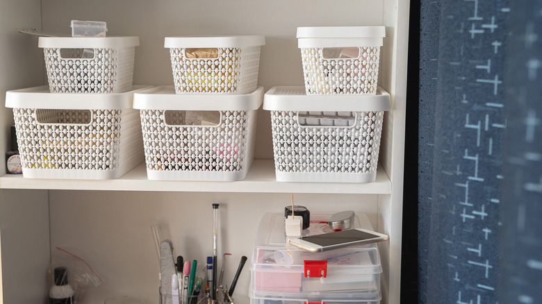 A bookcase with baskets used to store various practical supplies