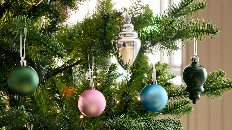 Examples of some of the variety in the bauble mixed pack from IKEA hanging on a tree
