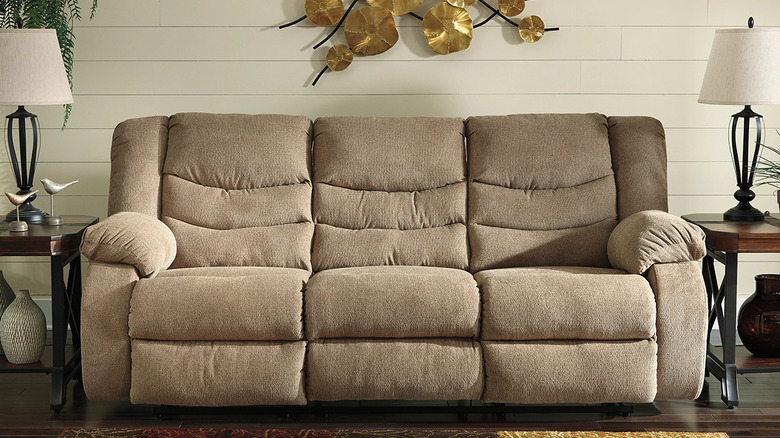 A bulky sofa and side tables