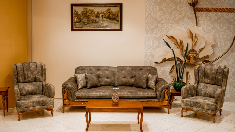 A living room with olive green furniture.