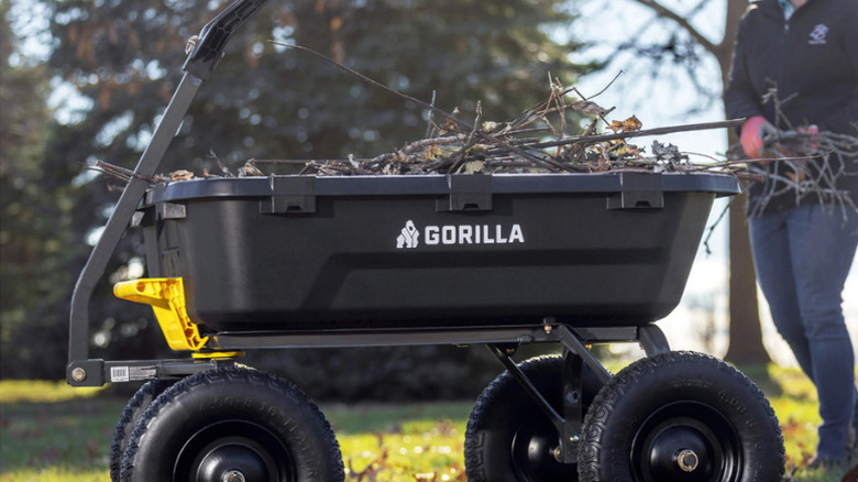 Gorilla's 9 cu ft. Heavy Duty Poly Yard Dump Cart in a garden