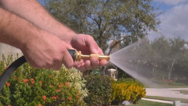 Man holding the Bionic Flex Pro hose while turning it on